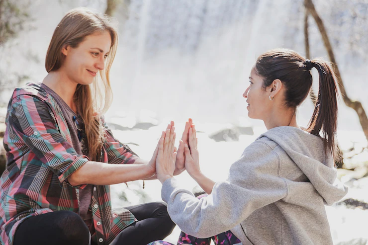 two women relaxed their hands together